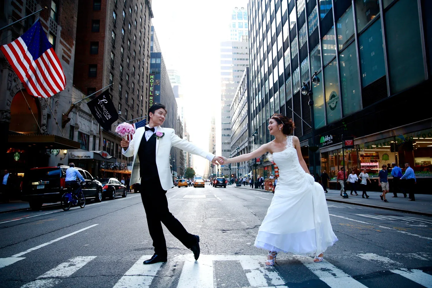 A couple crossing a Midtown street hand in hand