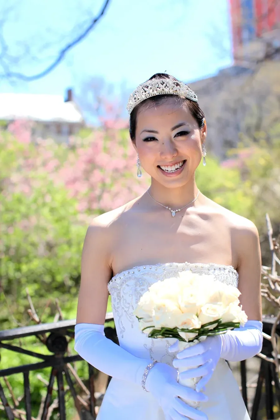 A bride holding white roses in Central Park in spring