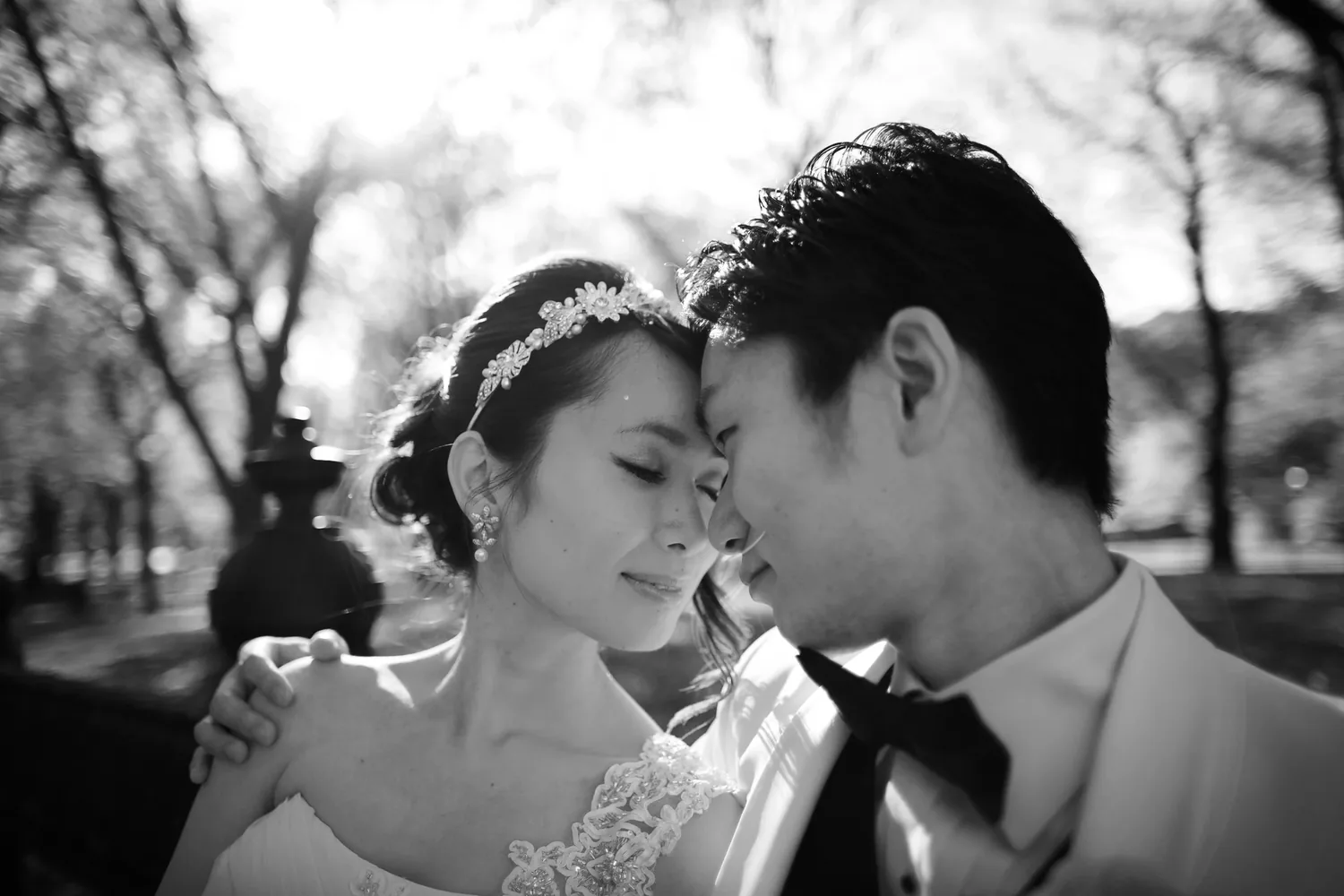 A couple resting their foreheads together, photographed in black and white