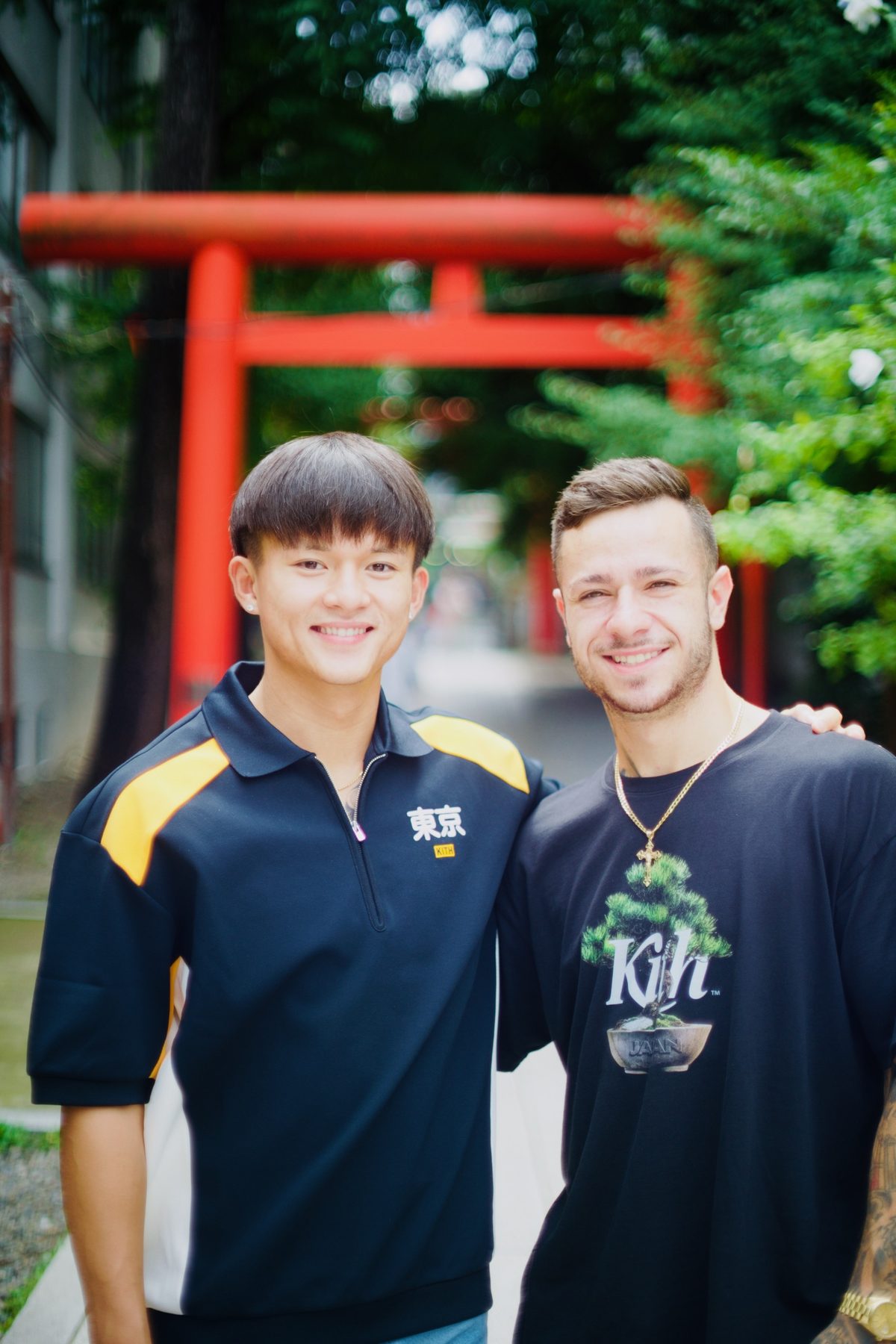 Two friends photographed in front of a torii gate