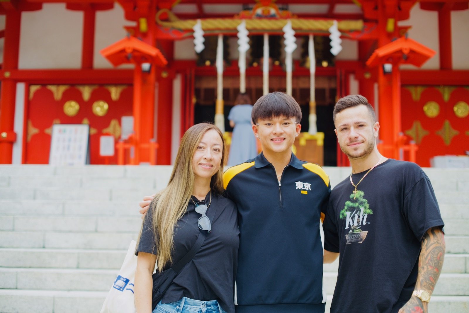 A family of three on the steps of Hanazono Shrine